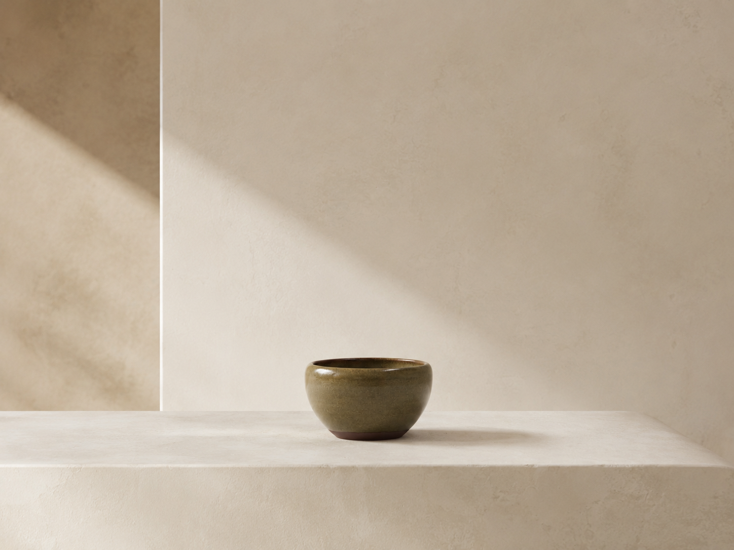 Ceramic form set against a quiet ivory architectural surface