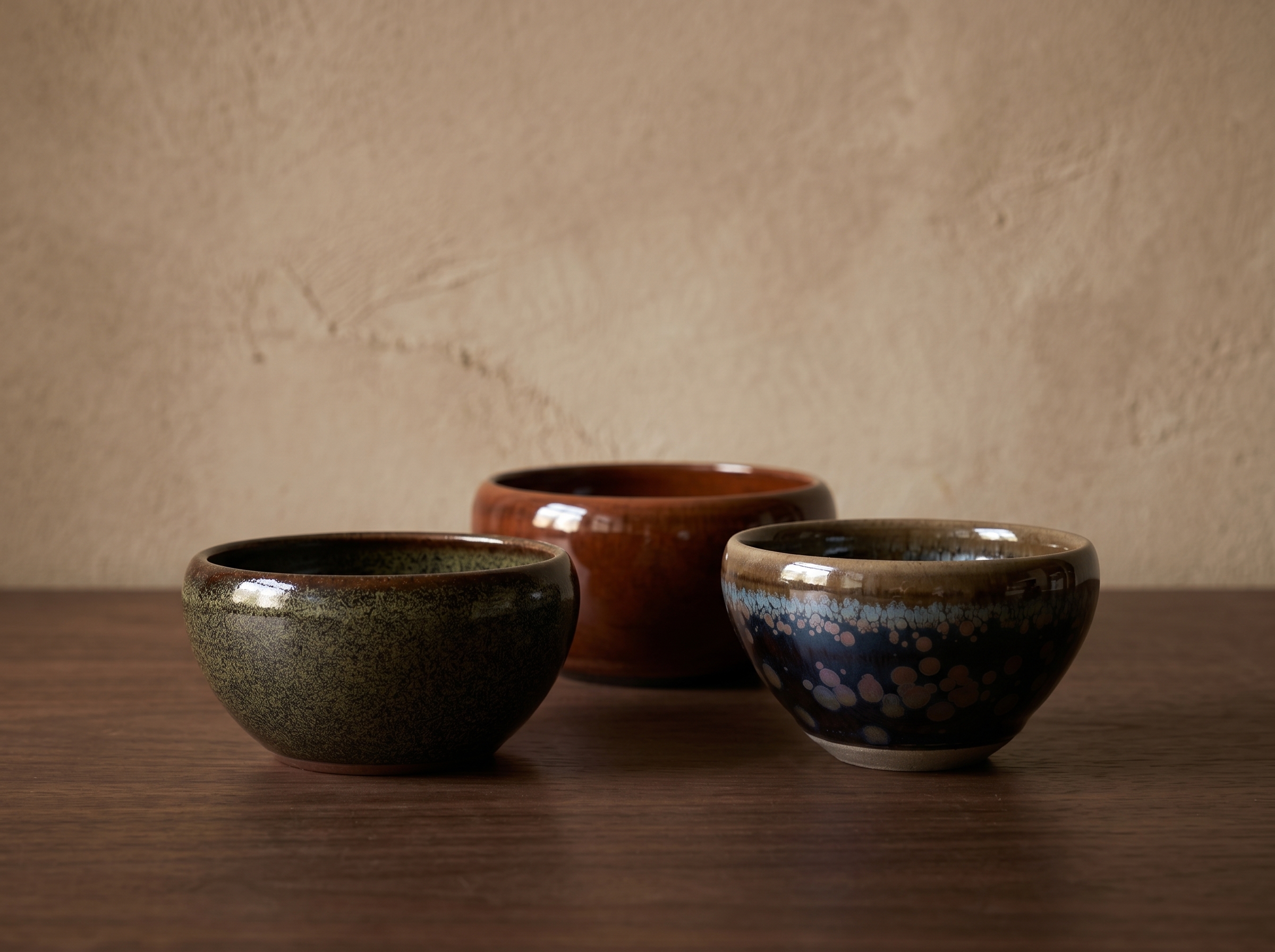 A group of three ceramic objects in warm directional light